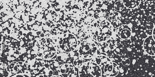 Abstract monochrome background with a dynamic pattern of irregular speckled circles and organic splotches in high contrast black and white, ideal for creative graphic design and textured overlays