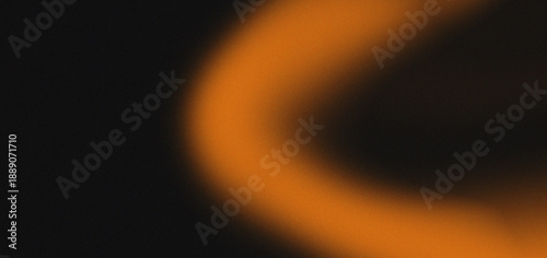 An abstract image featuring a blurred warm orange arc against a dark black background high-quality