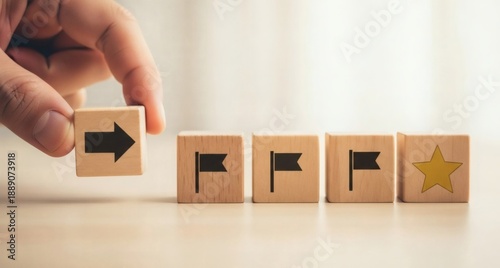 Goal Achievement Strategy. Hand aligning wooden blocks with arrows flags and star icon, symbolizing structured planning clear direction leadership and successful progress.
