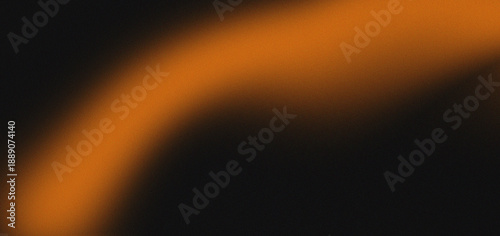 An abstract image featuring a blurred vibrant orange glow against a dark black background high-quality