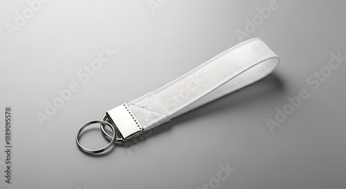 Elegant White Fabric Wrist Strap Keychain Mockup for Branding, Product Display, and Customization Design on a Neutral Grey Surface