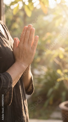 A person stands with hands ...