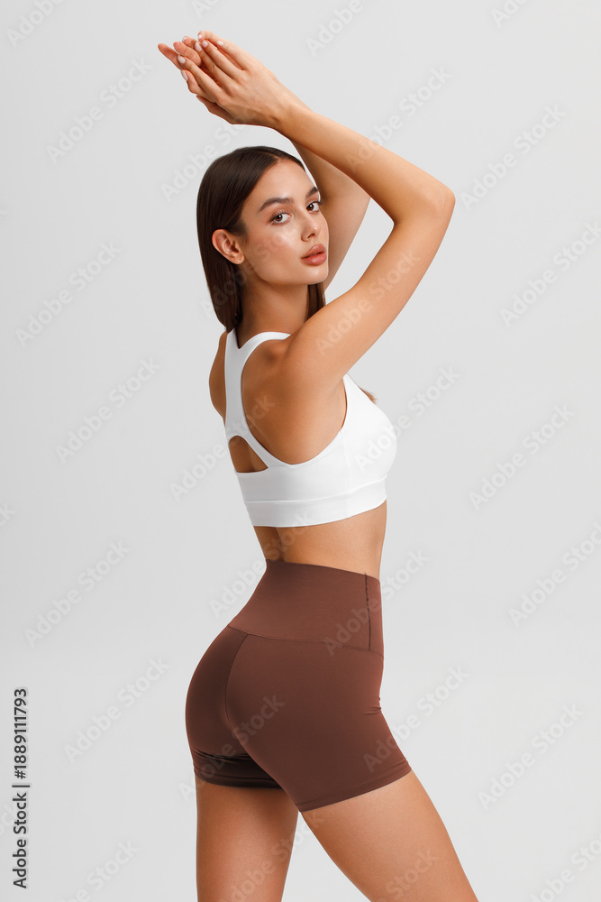 Fototapeta premium Athletic girl on the gray background. Fitness woman