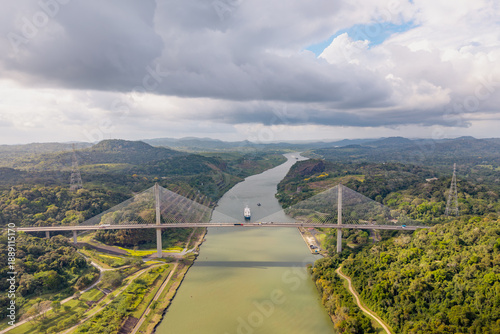 Quadro su tela Aerial view of Panama Canal bridge crossing tropical rainforest