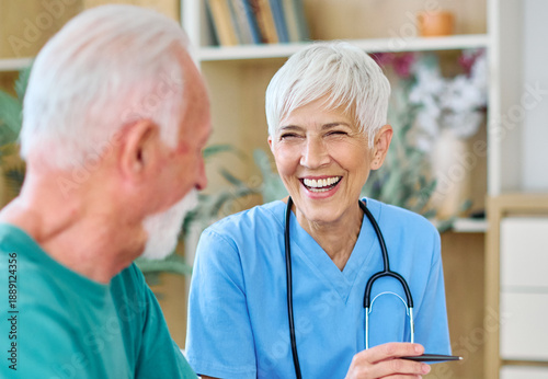 Portrait of a senior doctor or nurse caregiver talking consultation with senior man at home or nursing home