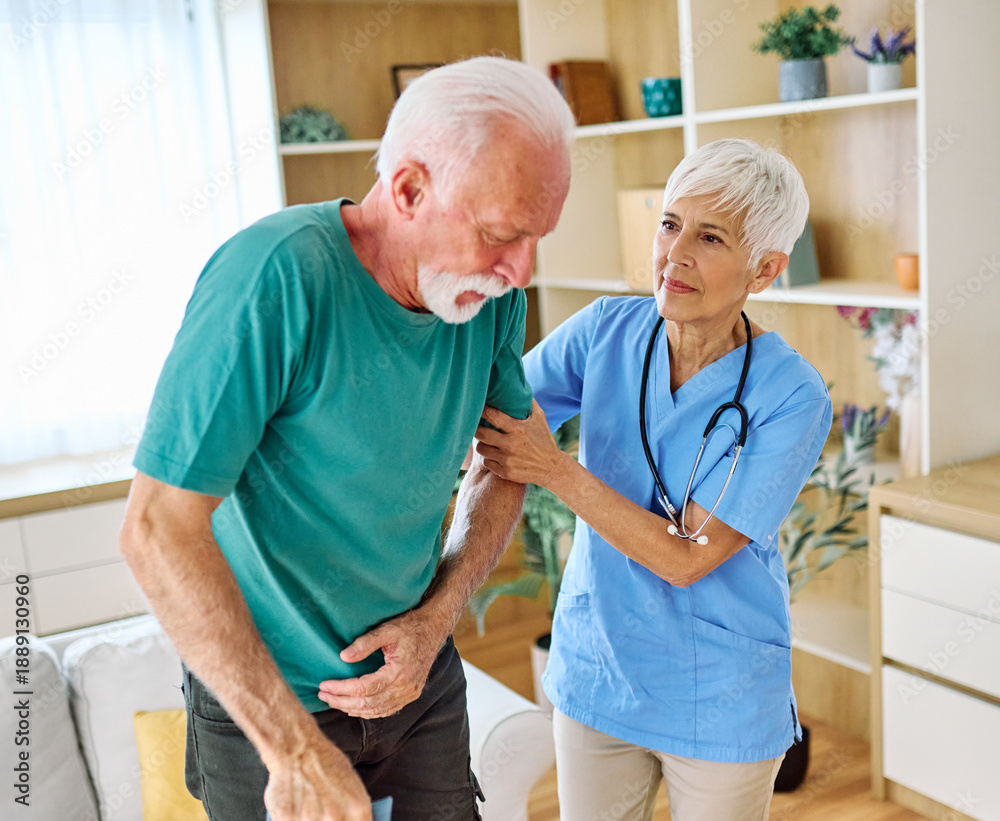 Fototapeta premium Doctor or nurse caregiver helping senior man holding walking cane at home or nursing home
