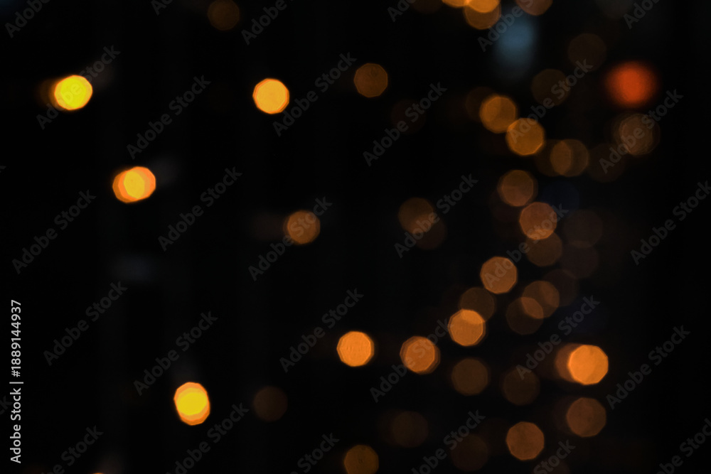 Obraz premium Warm orange bokeh lights creating sparkling and magical holiday atmosphere