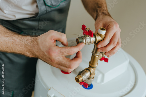 Valokuva Worker's hands applying waterproofing paste around a metal fitting on a water he