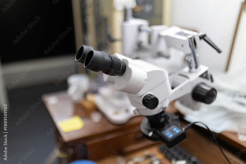 Fototapeta premium Stereo microscope on workbench magnifying details for precision work