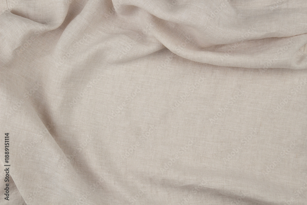 Fototapeta premium Soft draped beige linen background. Natural eco friendly fabric texture with draperies in left side
