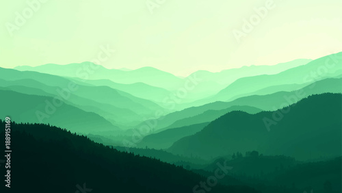 A scenic morning mountain landscape view features a misty blue range and hills shrouded in fog and clouds at dawn
