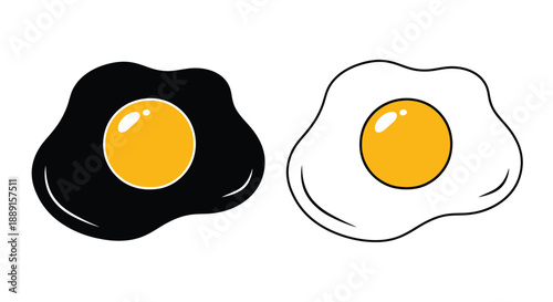 Two fried eggs one black and one white with bright yellow yolks