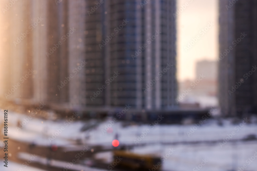 Fototapeta premium Nighttime urban snow scene, Snowcovered city with warm lights and misty twilight setting