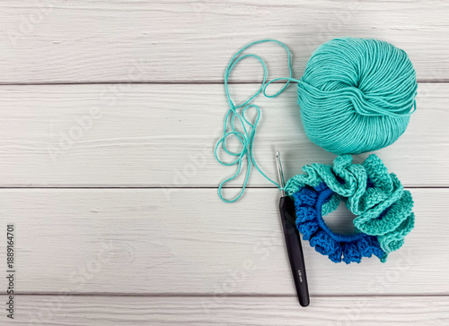 Canvastavla Yarn ball, crochet hook and ruffled scrunchie with copy space