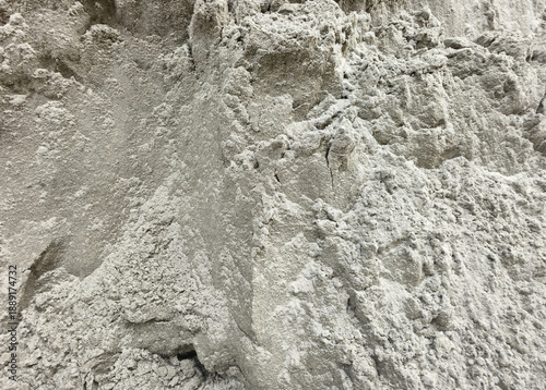 Texture of wet gray sand, background, texture. Close-up view of rough grey sand or dry cement texture with uneven, granular surface. Perfect for use in construction themes, industrial backgrounds. 