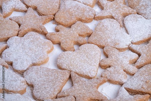 Decorative cookies with sugar dusting, Cookies featuring hearts and stars with powdered sugar, Delicious homemade cookies with decorated heart and star shapes dusted with powder