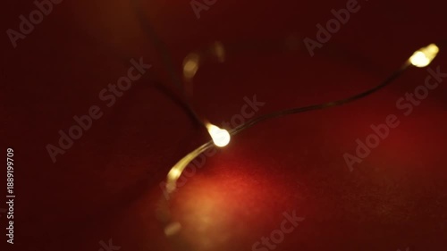 glowing christmas garland lights on red background