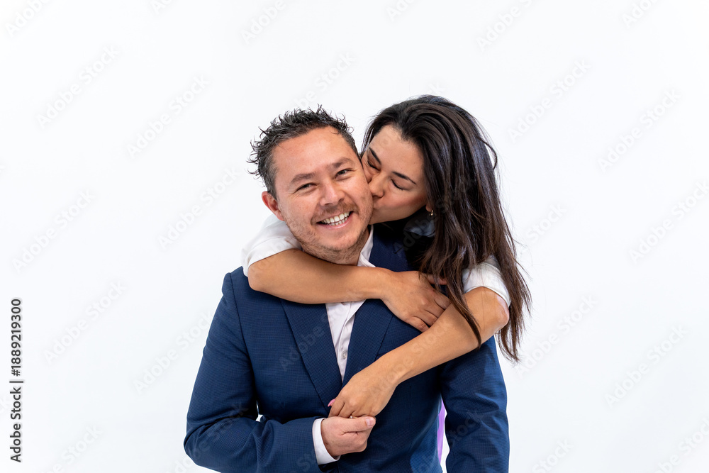 Fototapeta premium Happy couple embracing, woman kissing man's cheek