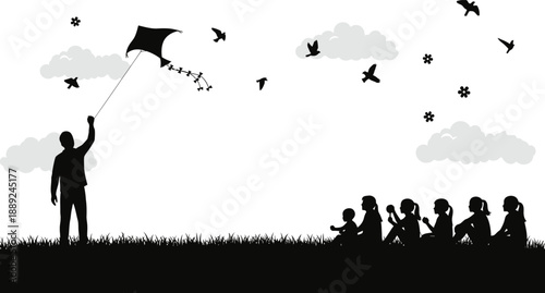 Silhouette of a man flying a kite with children sitting on the grass watching him play outdoors