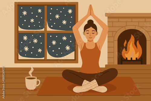 Person practicing yoga indoors during winter with a warm drink nearby near a fireplace