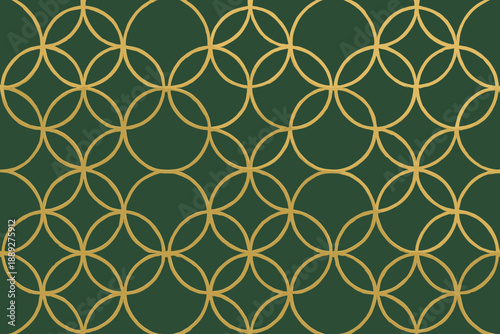 Pattern of interlocking circles in gold over green background on a wall