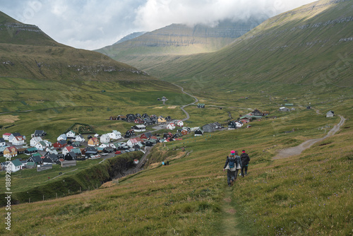 Photos Tourists walking toward Gjógv village and Gjógv gorge, Eysturoy, Faroe Islands