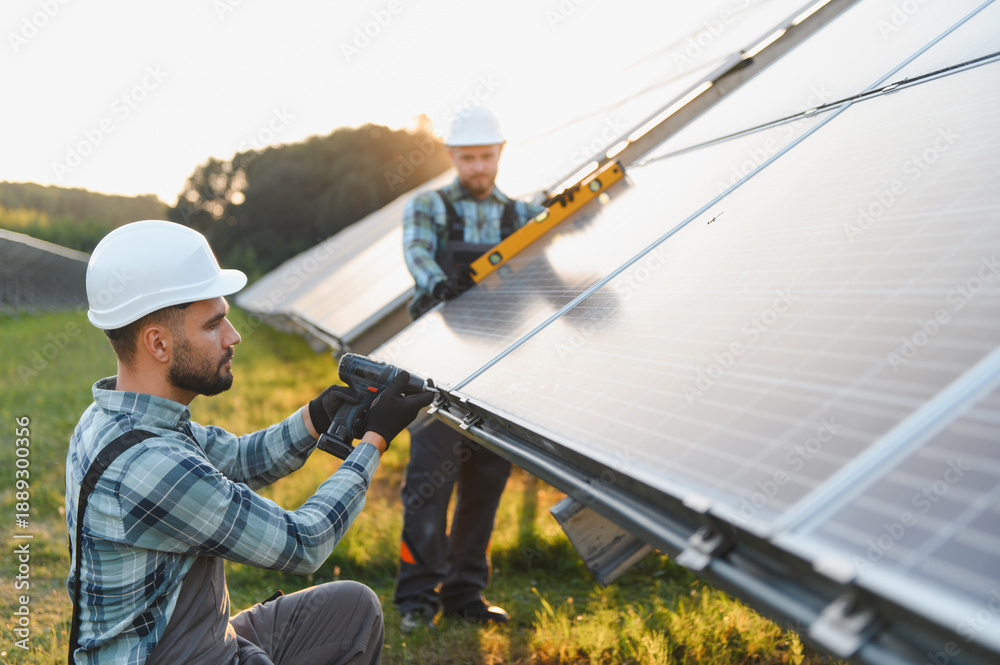 Naklejka premium Workers installing solar panels for renewable energy production