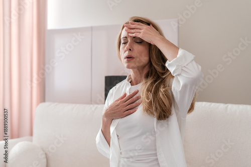 Photos Mature woman experiencing chest pain and difficulty breathing at home