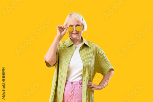 Stylish senior woman in sun...
