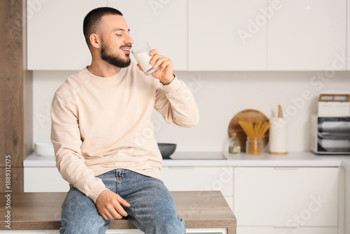 Handsome man drinking milk ...