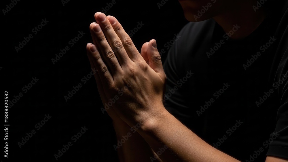 Fototapeta premium Man Praying Hands Dark Background