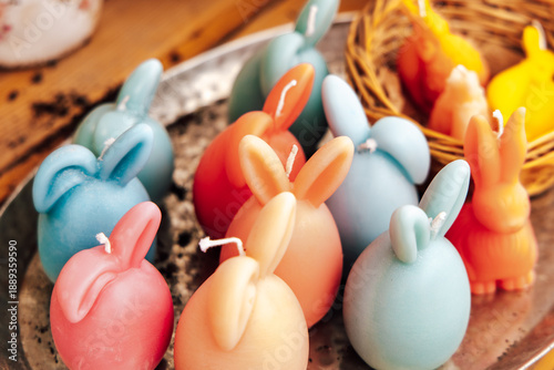 Photos Bunnies made of wax in various colors sit on a tray alongside other decorative i