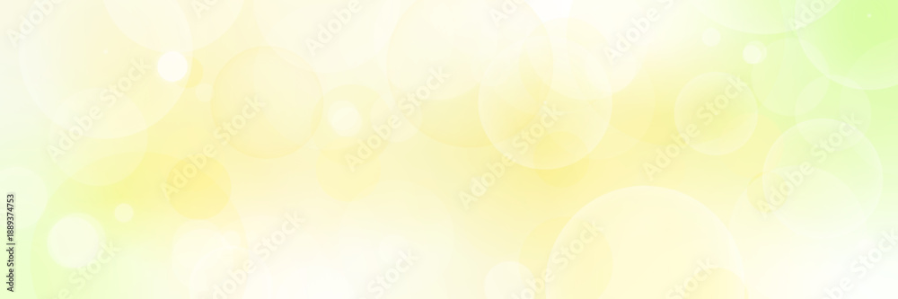 Naklejka premium 明るいグリーンとイエローの抽象背景｜やさしい光とバブル・玉ボケのベクター 横長