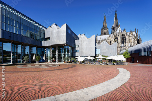 Wide angle view of the circular brick patterns at Heinrich-Boell-Platz square, featuring the modern Museum Ludwig and Cologne Cathedral behind