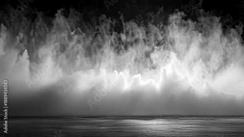 Mist and fog hovering above a dark body of water illuminated by a faint light source from below the surface at dusk from an aerial viewpoint