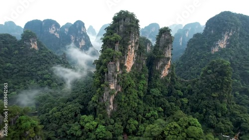 Dynamic aerial drone footage showcases majestic zhangjiajie national forest park mountains and lush forest, creating a breathtaking natural landscape