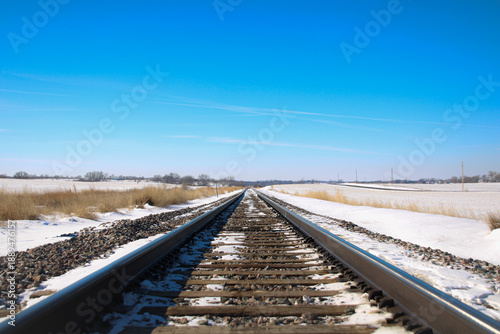 Foto winter railroad tracks along rural road, endless path toward somewhere, never-en