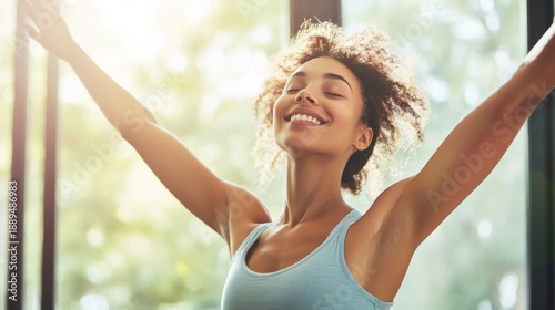 Woman Stretching Arms in Sunny Room.