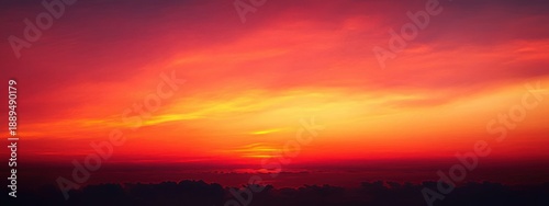 Panel kuchenny z motywem Vibrant orange and red sunset sky with layered clouds creating a serene and warm atmosphere over a dark horizon