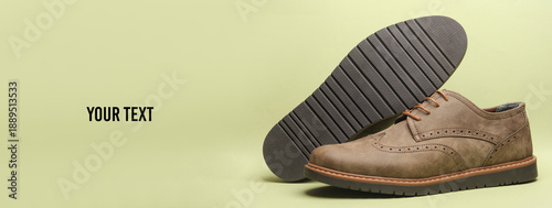 Φωτογραφία Leather brogue shoes on green background