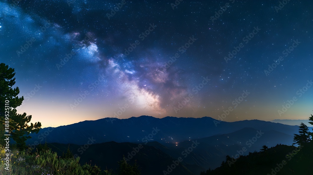 Fototapeta premium Milky Way galaxy over dark mountain range at night