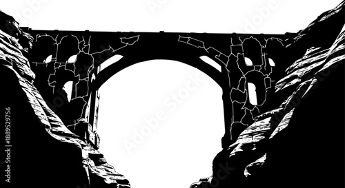 Silhouette of an ancient stone arch bridge in a rocky canyon