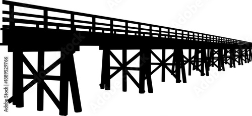 Silhouette of a long wooden trestle bridge stretching away