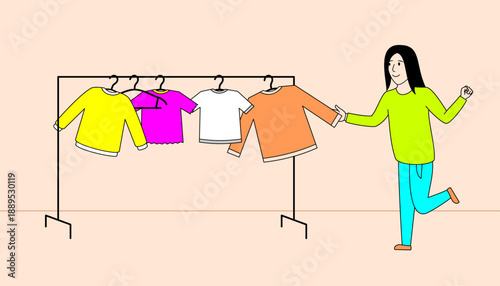Woman is standing in front of a rack of clothes, holding a shirt