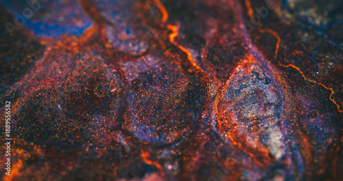 Defocused shimmering background. Ink stream. Heat magma burning in volcanic colorful texture. Orange red dye lava spill on abstract black particles.