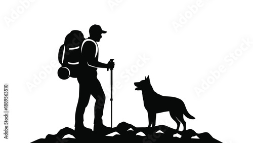 A hiker and his dog standing on a mountain peak at sunset