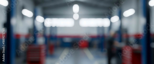 Wallpaper Mural Blurry interior view of a brightly lit vehicle repair workshop with lifts, soft industrial lighting, spacious garage atmosphere, and indistinct shapes creating a modern abstract workspace mood. Torontodigital.ca
