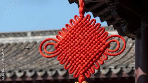 Red Chinese knot hanging on traditional eaves
