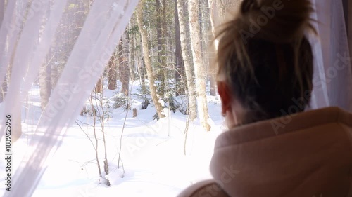 Quiet winter self care moment woman reflects by window during long winter days Mental health focus emotional balance mindful pause with forest view snow outside snow silence snow light calming