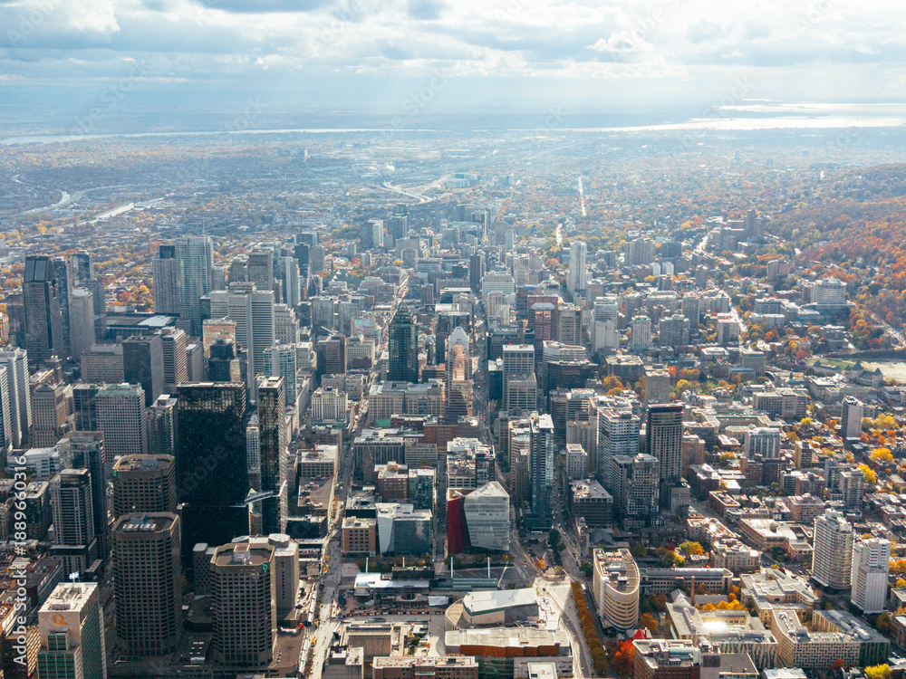 Obraz premium Autumn aerial view of Montreal downtown skyline with high-rise buildings under cloudy sky. g